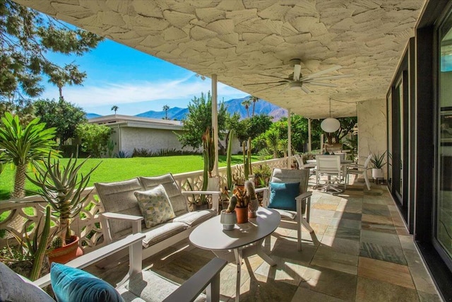 view of patio / terrace with a mountain view and ceiling fan