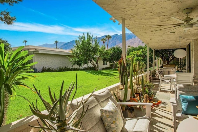 view of patio / terrace with a mountain view, area for grilling, and ceiling fan