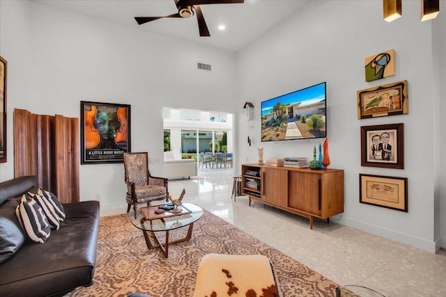 living room with a high ceiling and ceiling fan