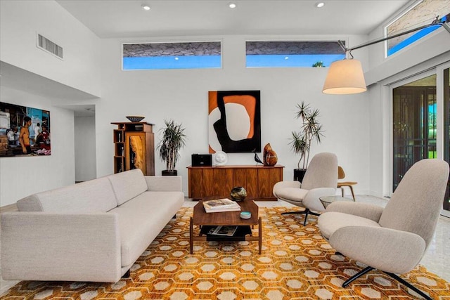 living room featuring a high ceiling and plenty of natural light