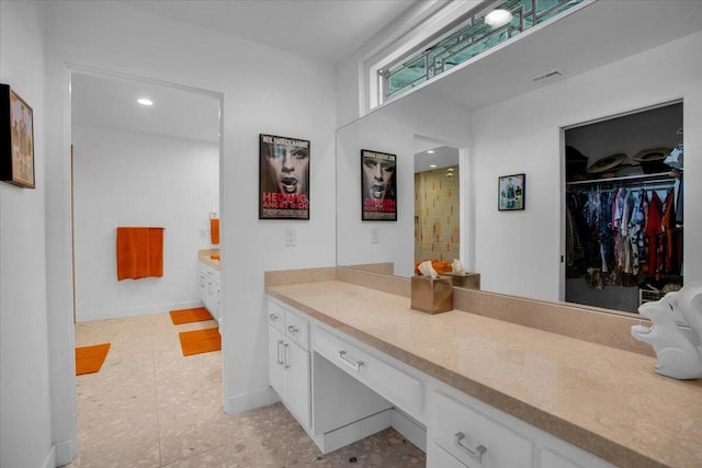 bathroom featuring vanity, tile patterned floors, and walk in shower