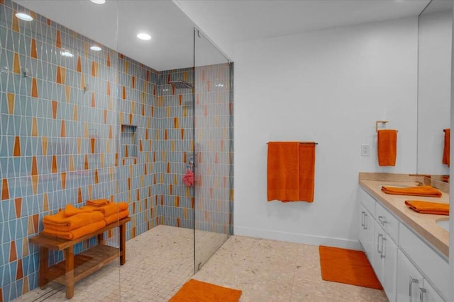 bathroom featuring vanity, tile walls, and tiled shower