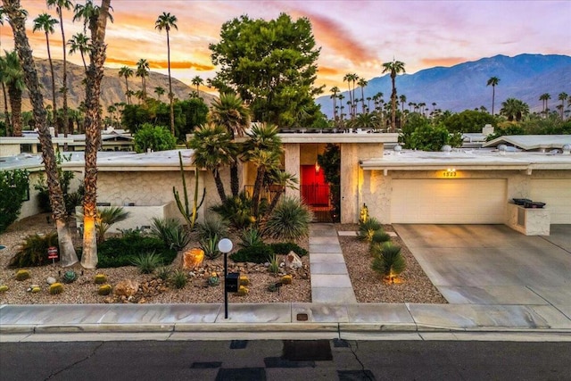 view of front of property featuring a mountain view and a garage