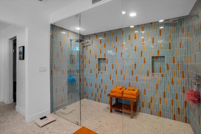 bathroom featuring tile walls and tiled shower