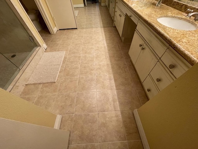 bathroom with vanity, tile patterned floors, and walk in shower