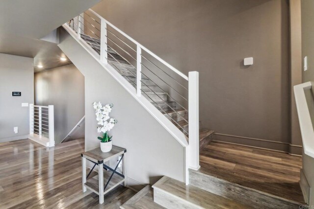 stairs featuring hardwood / wood-style floors