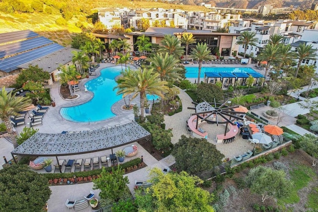 view of pool featuring a patio area and a residential view