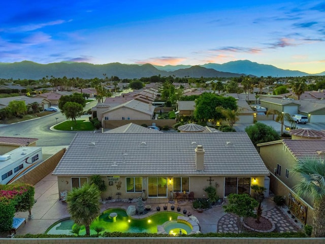 aerial view at dusk featuring a mountain view