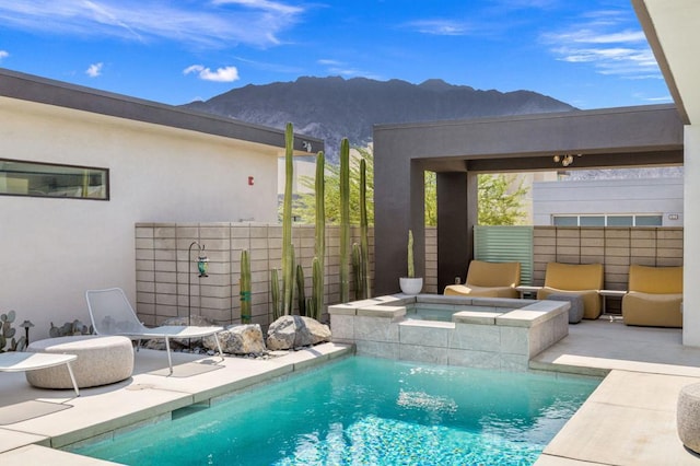 view of swimming pool with a mountain view, an in ground hot tub, and a patio