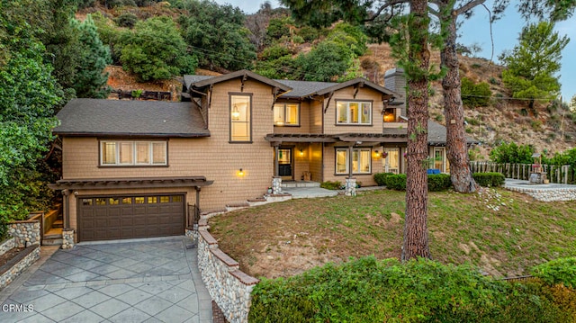 craftsman house with a front yard and a garage