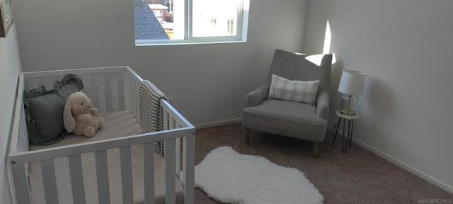 bedroom with carpet floors and a nursery area