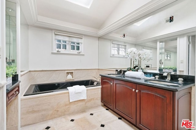 bathroom featuring tile patterned floors, vanity, lofted ceiling, and tiled tub