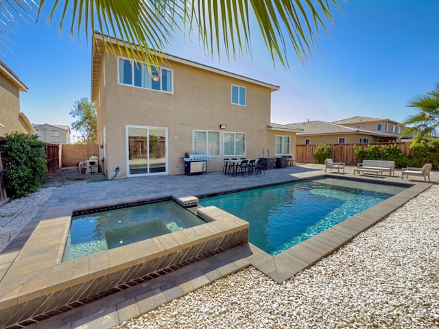 view of swimming pool with an in ground hot tub and a patio area