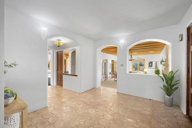 empty room featuring beamed ceiling