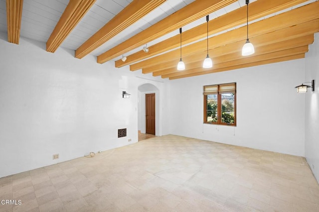 unfurnished room featuring beam ceiling