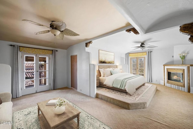 carpeted bedroom with ceiling fan, lofted ceiling, and french doors