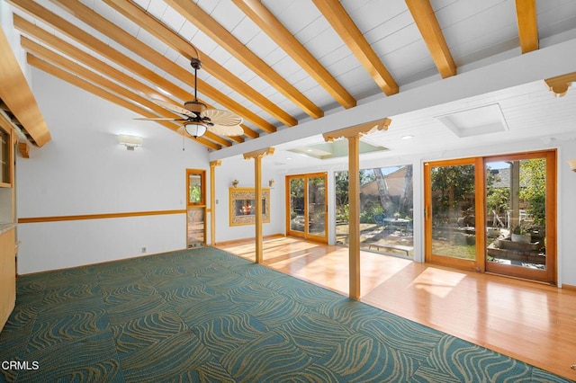 interior space featuring ceiling fan, lofted ceiling with beams, and french doors