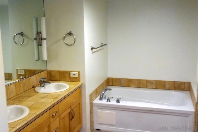 bathroom featuring a washtub and vanity