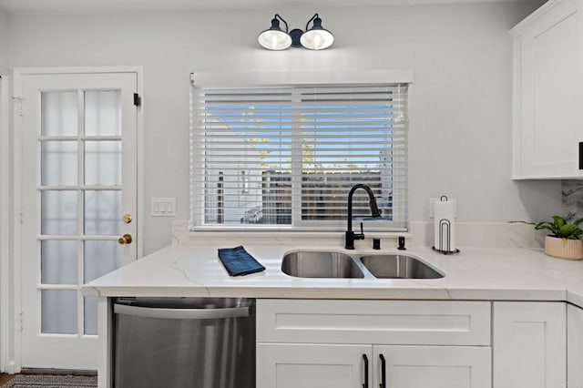 kitchen with white cabinetry, dishwasher, sink, and light stone countertops