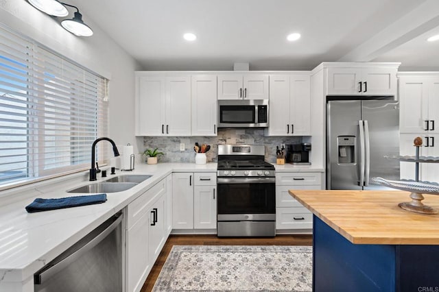 kitchen featuring white cabinetry, sink, and stainless steel appliances