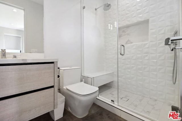 bathroom featuring vanity, toilet, and walk in shower