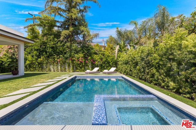 view of pool with a lawn and an in ground hot tub