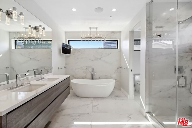 full bathroom featuring shower with separate bathtub, vanity, toilet, and a notable chandelier