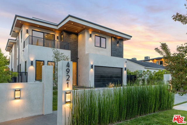 contemporary house featuring a balcony and a garage