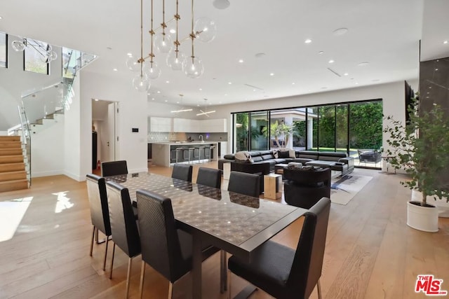 dining room featuring light hardwood / wood-style flooring and a notable chandelier