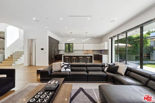 living room with light hardwood / wood-style floors and a healthy amount of sunlight