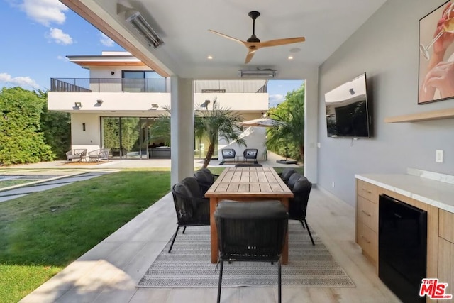 view of patio / terrace with ceiling fan and a balcony