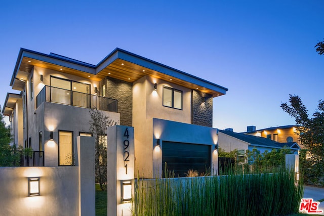 contemporary house with a balcony and a garage