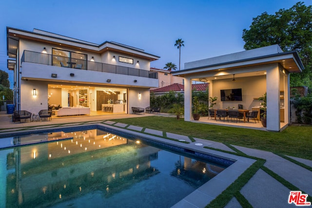 back of house featuring an outdoor hangout area, a balcony, a patio, and ceiling fan