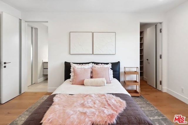 bedroom featuring light hardwood / wood-style floors and a closet