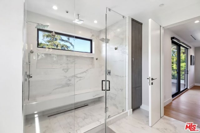 bathroom featuring a shower with shower door and wood-type flooring