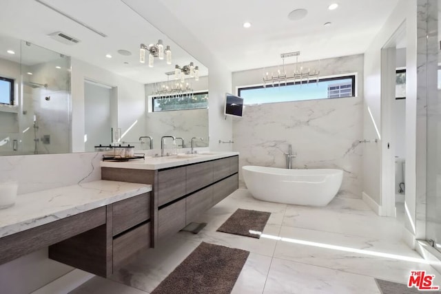 bathroom featuring plenty of natural light, separate shower and tub, tile walls, and vanity