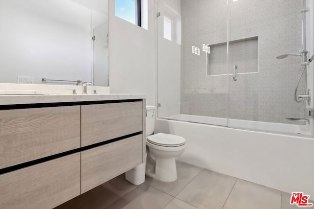 full bathroom featuring tile patterned floors, shower / bath combination with glass door, vanity, and toilet