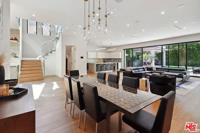 dining space with a chandelier and light wood-type flooring