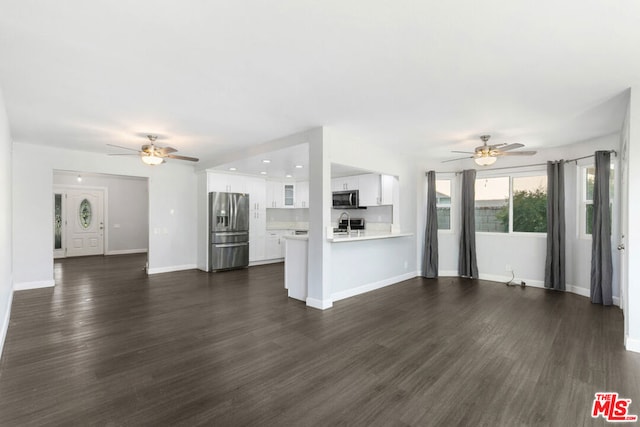 unfurnished living room featuring ceiling fan, dark wood-type flooring, and sink