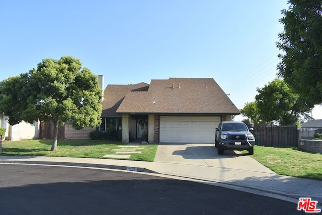 view of front of house with a garage and a front yard