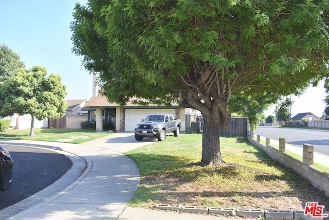 view of front of property featuring a front yard and a garage