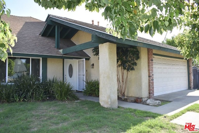 view of front facade with a front yard and a garage