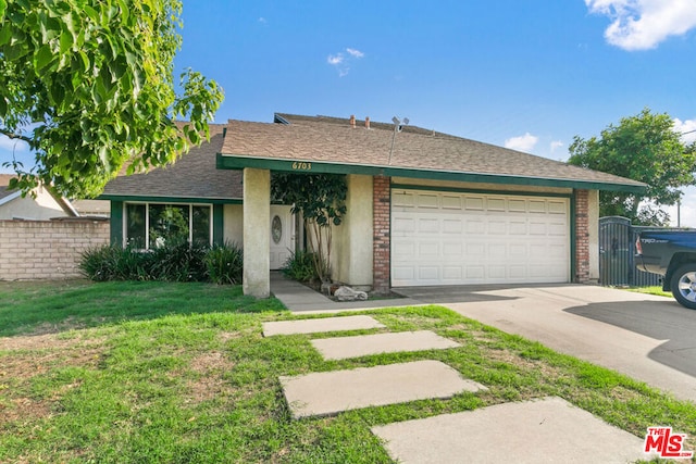 view of front of house with a front yard and a garage