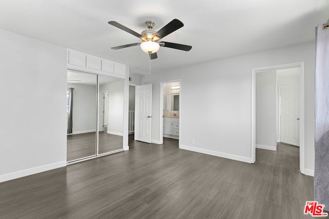 unfurnished bedroom with dark hardwood / wood-style flooring, ensuite bath, a closet, and ceiling fan