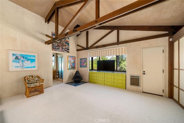 carpeted living room with heating unit, beamed ceiling, and high vaulted ceiling