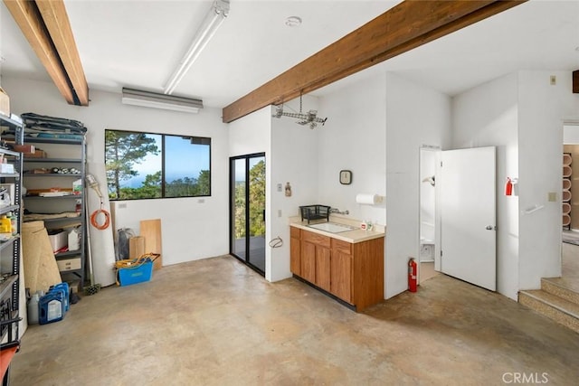 kitchen with sink and beamed ceiling