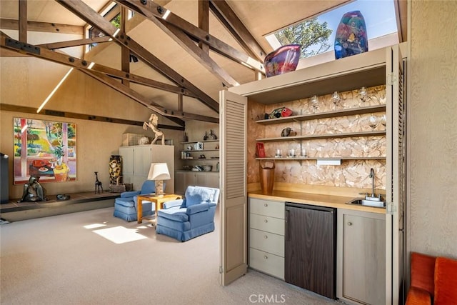 bar with lofted ceiling with beams, stainless steel refrigerator, sink, and light carpet