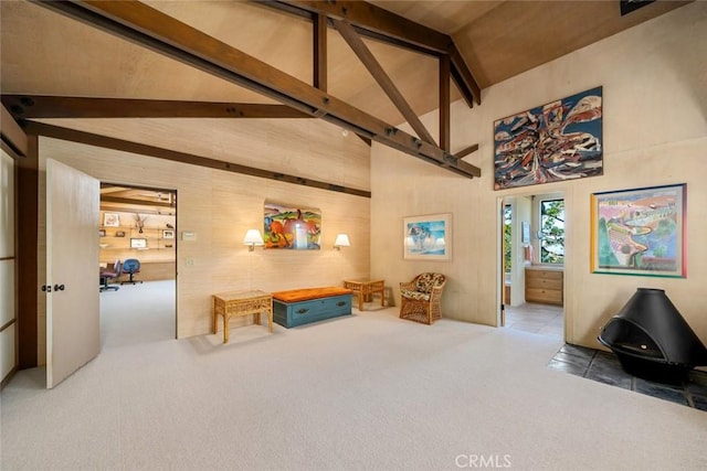 living area featuring beam ceiling, carpet floors, and high vaulted ceiling