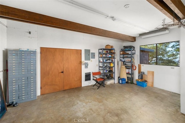 garage featuring electric panel and heating unit