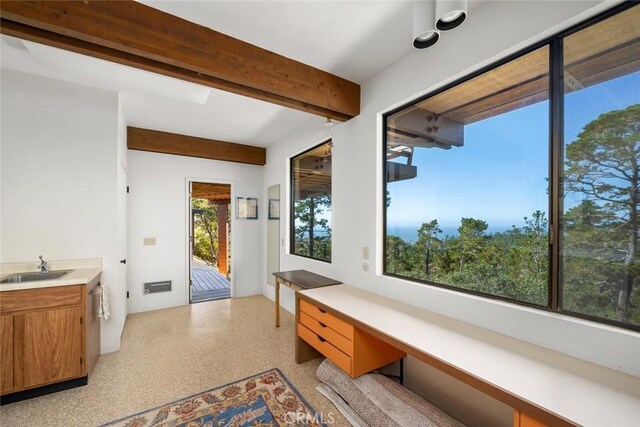 interior space with beam ceiling and sink